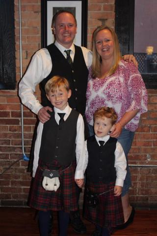 family picture with a husband wife and two young boys